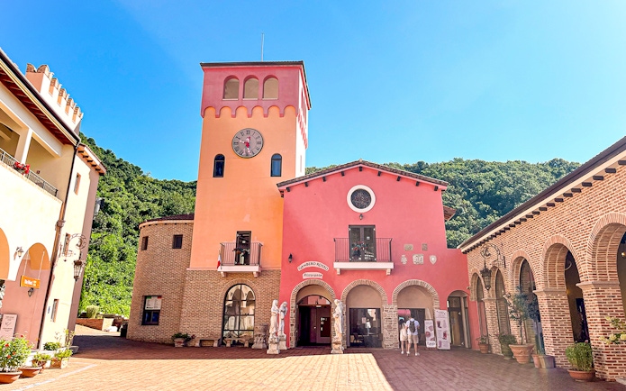 Clock tower and pink building in Italian Village Pinocchio e Da Vinci, South Korea.