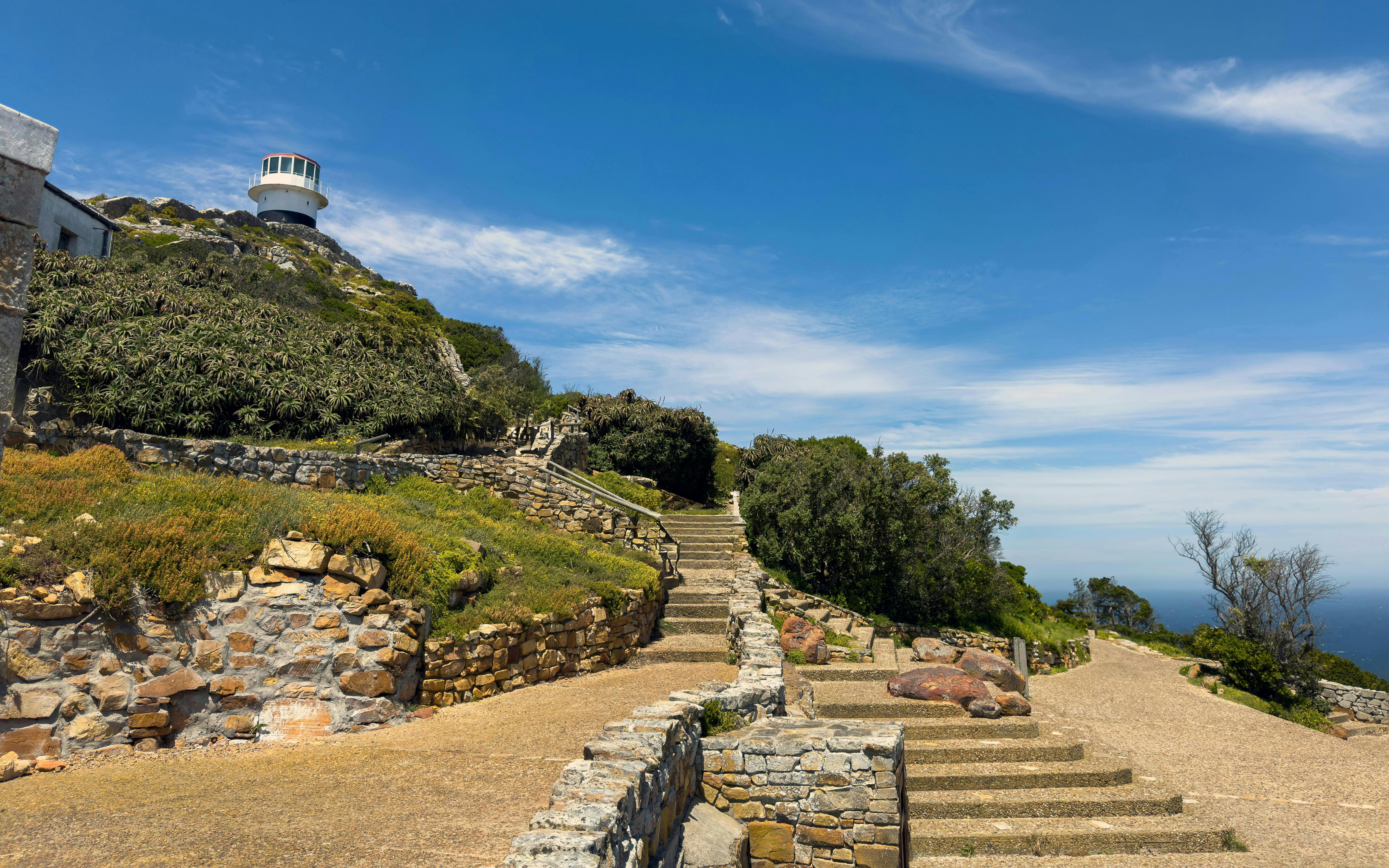 Cape Point lighthouse on rocky cliffs, Cape of Good Hope, South Africa.