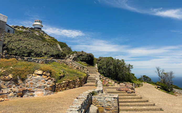 Cape Point lighthouse on rocky cliffs, Cape of Good Hope, South Africa.