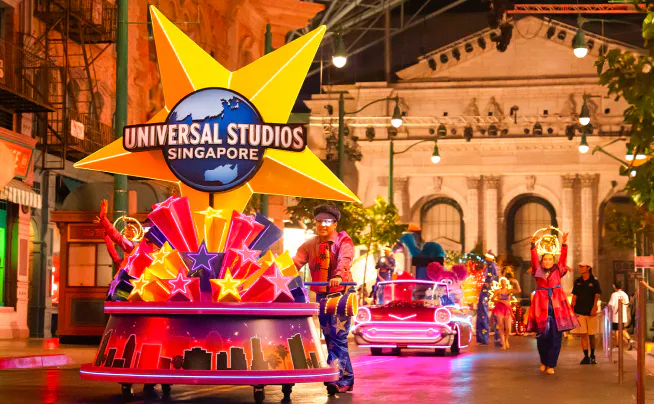 Universal Studios Singapore parade with illuminated floats and performers.