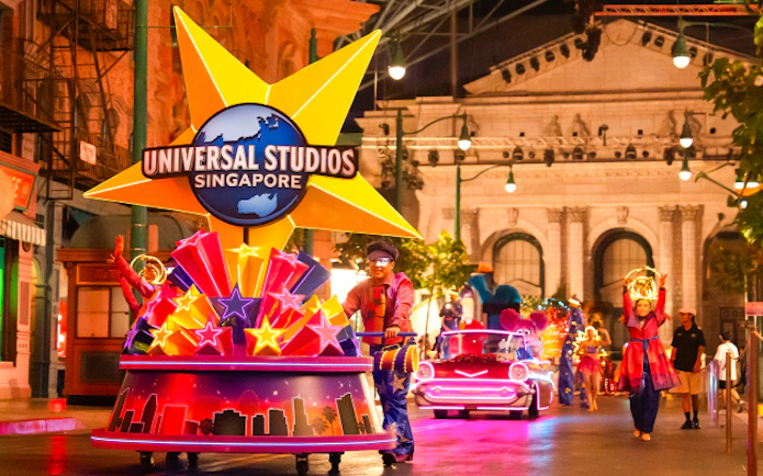 Universal Studios Singapore parade with illuminated floats and performers.