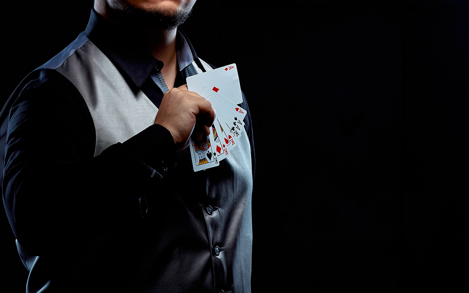 Magician holding a fan of playing cards during a trick.