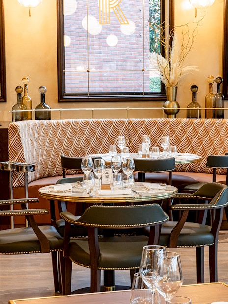 Brasserie Rosalie dining area with set tables and patterned seating.