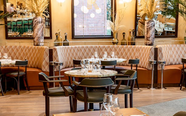 Brasserie Rosalie dining area with set tables and patterned seating.