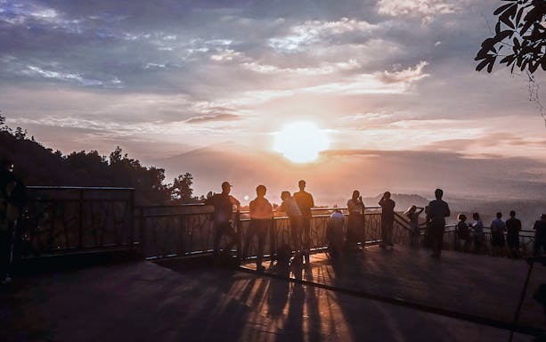 People enjoying a sunrise view from a scenic overlook on a private day tour.