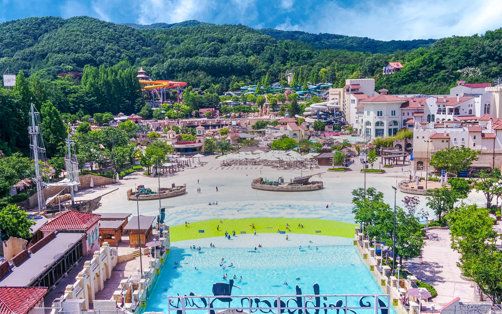Caribbean Bay Water Park overview with pools, slides, and surrounding greenery.