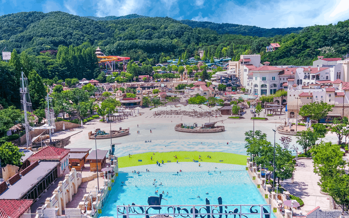Caribbean Bay Water Park overview with pools, slides, and surrounding greenery.