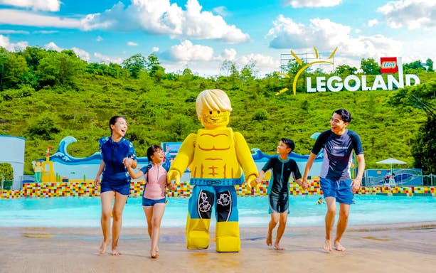 Family enjoying Legoland Water Park with Lego figure, Malaysia.