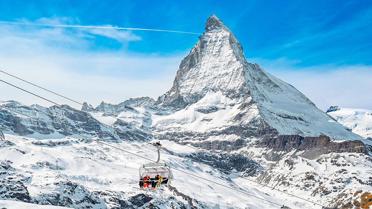Ski lift ascending towards Matterhorn Glacier Paradise in snowy Alps.
