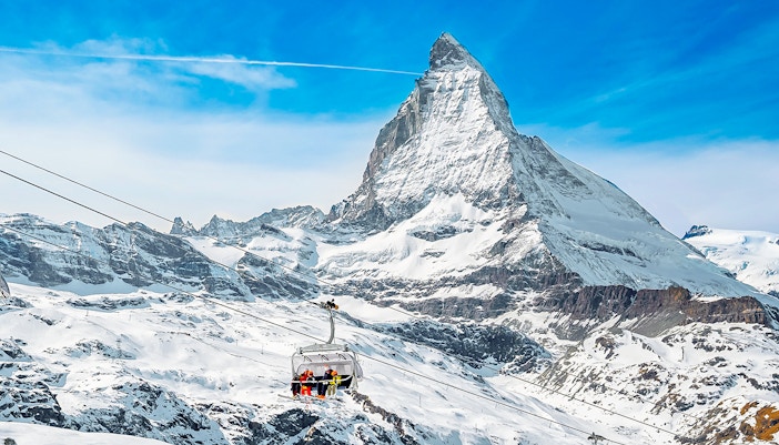 Ski lift ascending towards Matterhorn Glacier Paradise in snowy Alps.