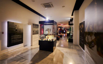 Sevilla FC History Experience museum interior with football memorabilia displays.