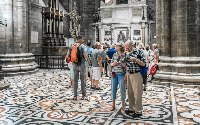 Tourists exploring the interior of Duomo Cathedral, Milan.