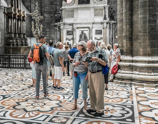Tourists exploring the interior of Duomo Cathedral, Milan.