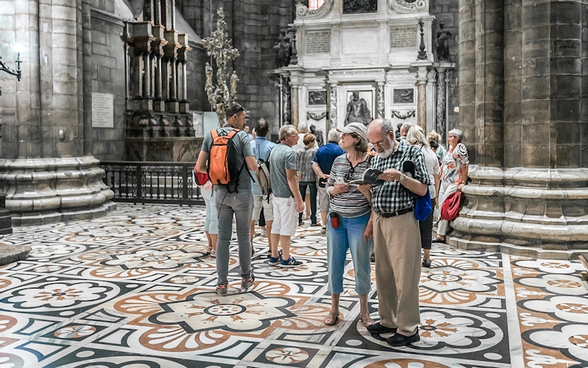 Tourists exploring the interior of Duomo Cathedral, Milan.