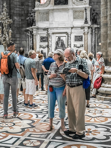 Tourists exploring the interior of Duomo Cathedral, Milan.