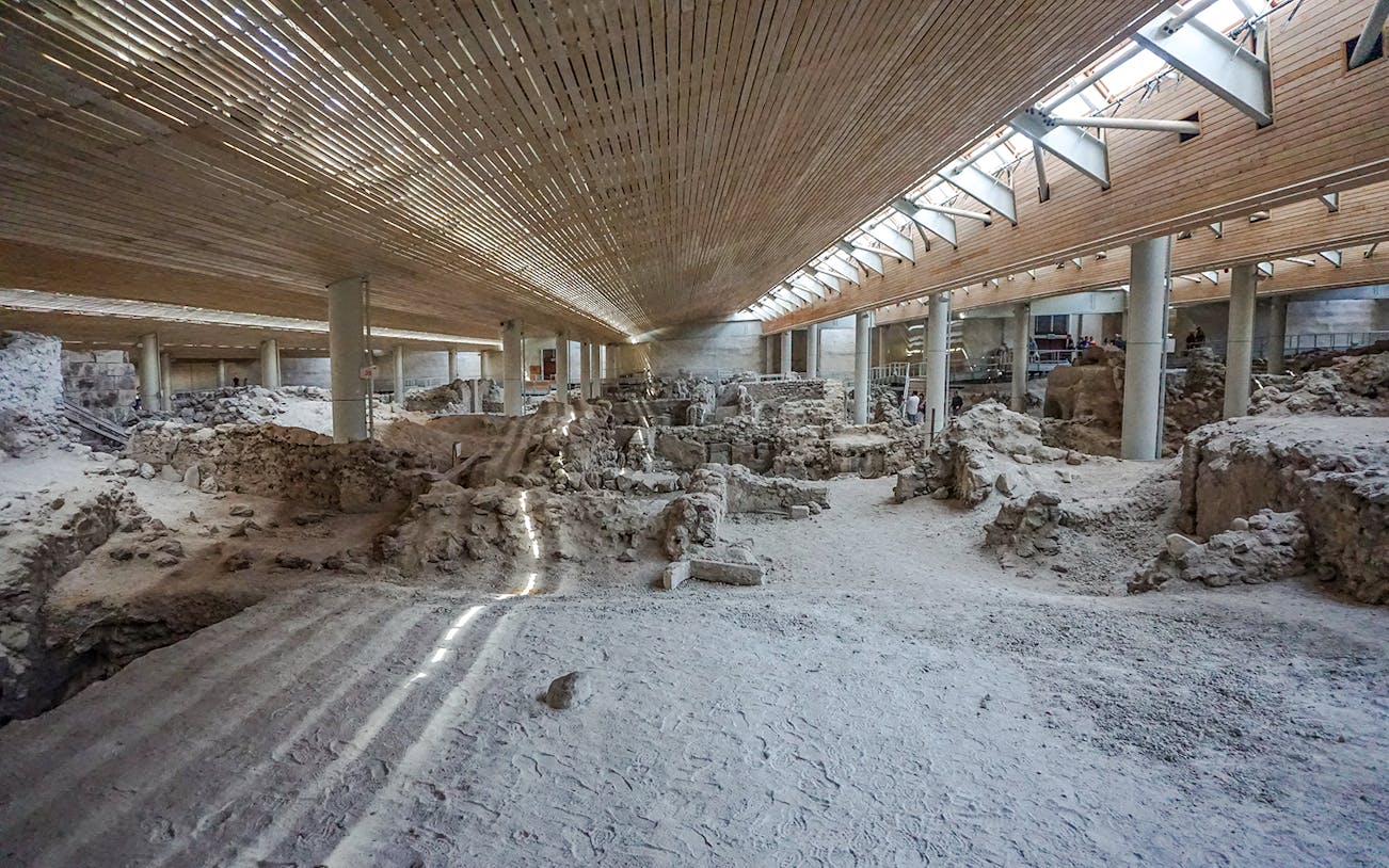 Inside the archaeological site of Akrotiri ruins, Santorini, showcasing ancient structures.