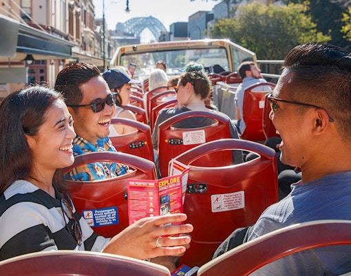 Passengers on Big Bus Sydney tour passing Sydney Opera House