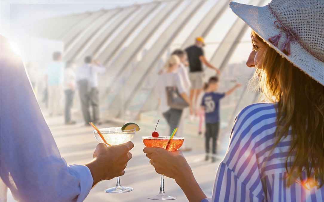 Couple toasting with cocktails at The View at the Palm, Dubai.