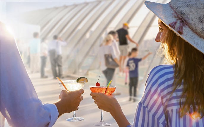 Couple toasting with cocktails at The View at the Palm, Dubai.