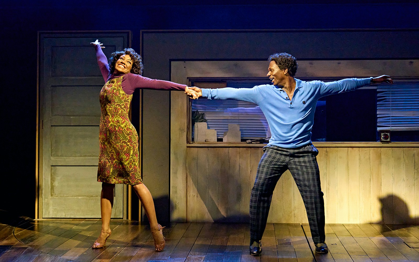 Performers dancing in TINA: The Tina Turner Musical stage scene.