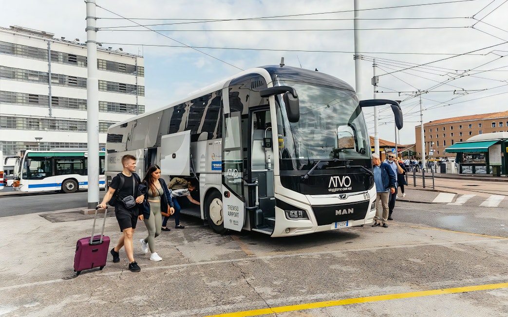 Bus at Venice Marco Polo Airport with passengers boarding for Piazzale Roma.