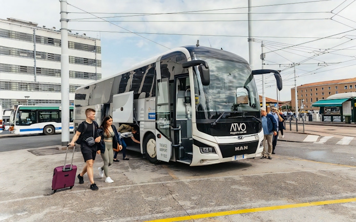 Bus at Venice Marco Polo Airport with passengers boarding for Piazzale Roma.