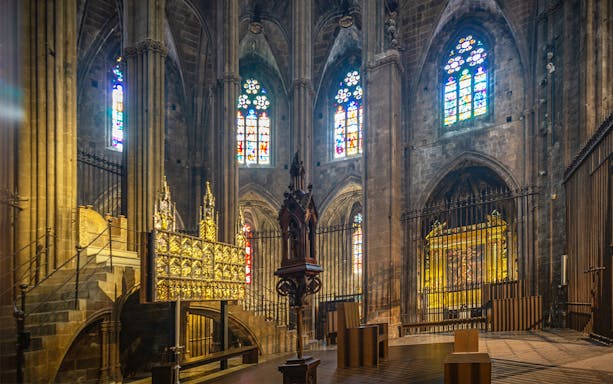 Stained glass windows and ornate altar inside the Cathedral of Girona.