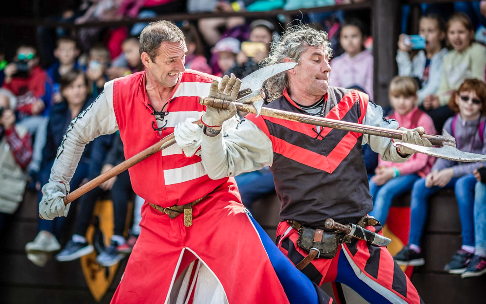 Performers in medieval costumes engaging in combat during the Medieval Show in Visegrád.