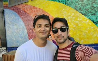 Colorful mural in Haight Ashbury, San Francisco, with two people in front.
