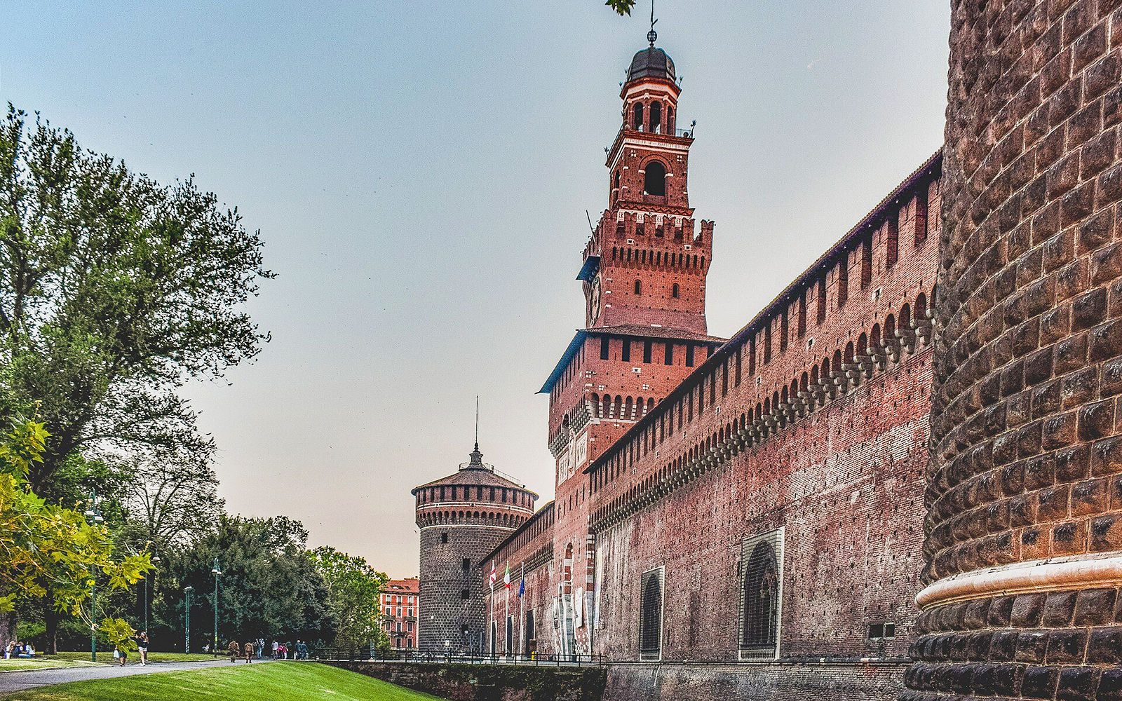 Sforza Castle in Milan with its iconic red brick walls and central tower.