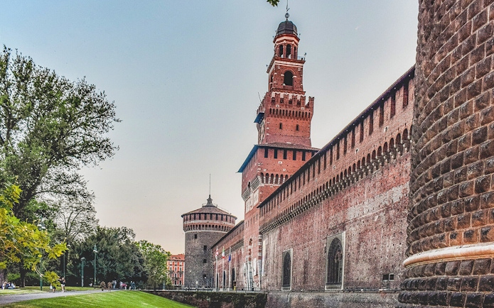 Sforza Castle in Milan with its iconic red brick walls and central tower.