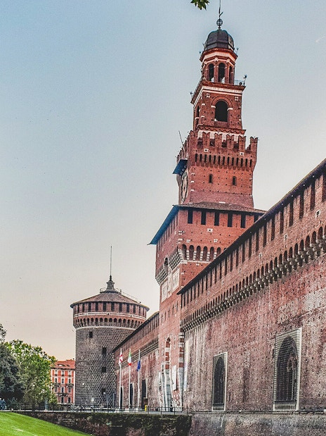 Sforza Castle in Milan with its iconic red brick walls and central tower.