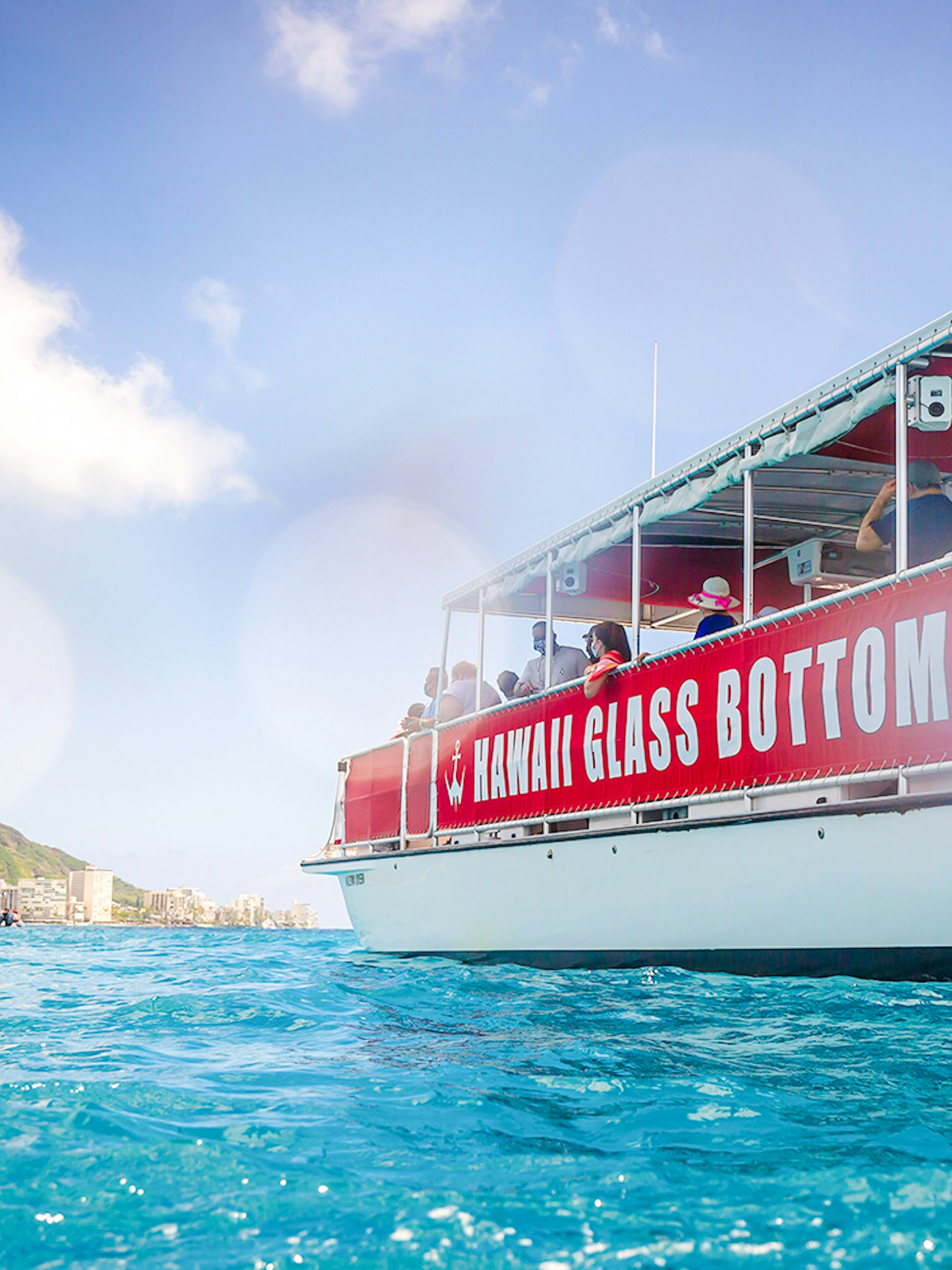Hawaii glass-bottom boat tour near Waikiki with Diamond Head in the background.