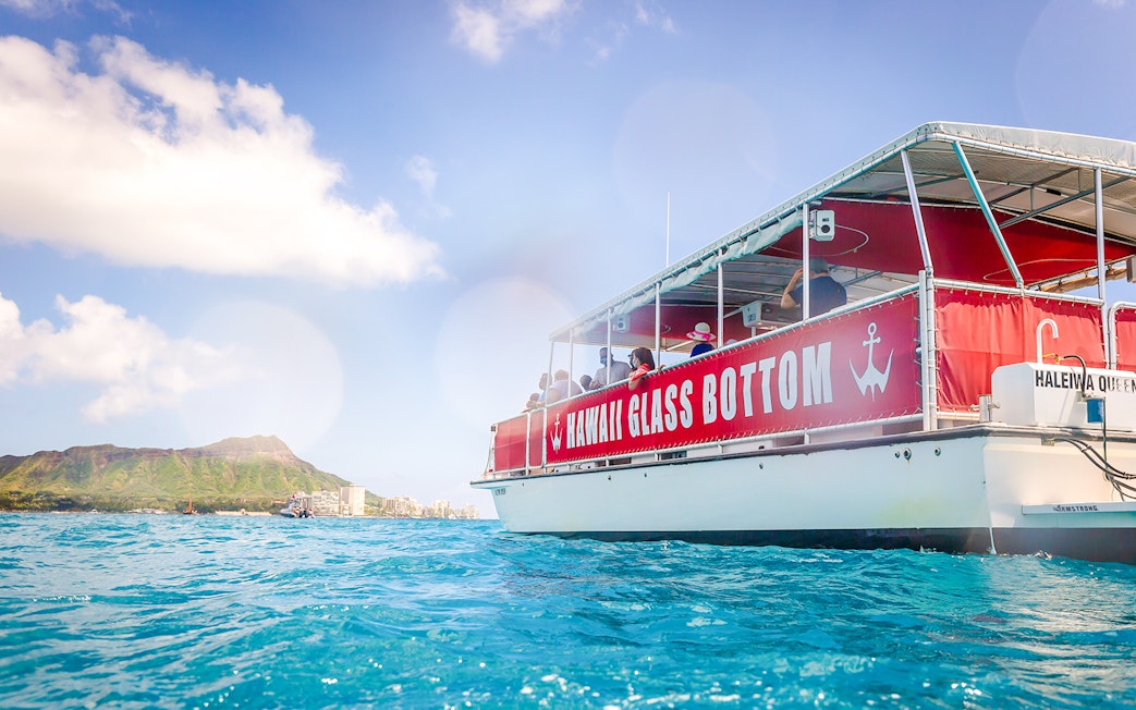 Hawaii glass-bottom boat tour near Waikiki with Diamond Head in the background.