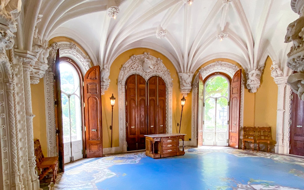 Quinta da Regaleira ornate room with arched ceiling and wooden doors in Sintra, Portugal.