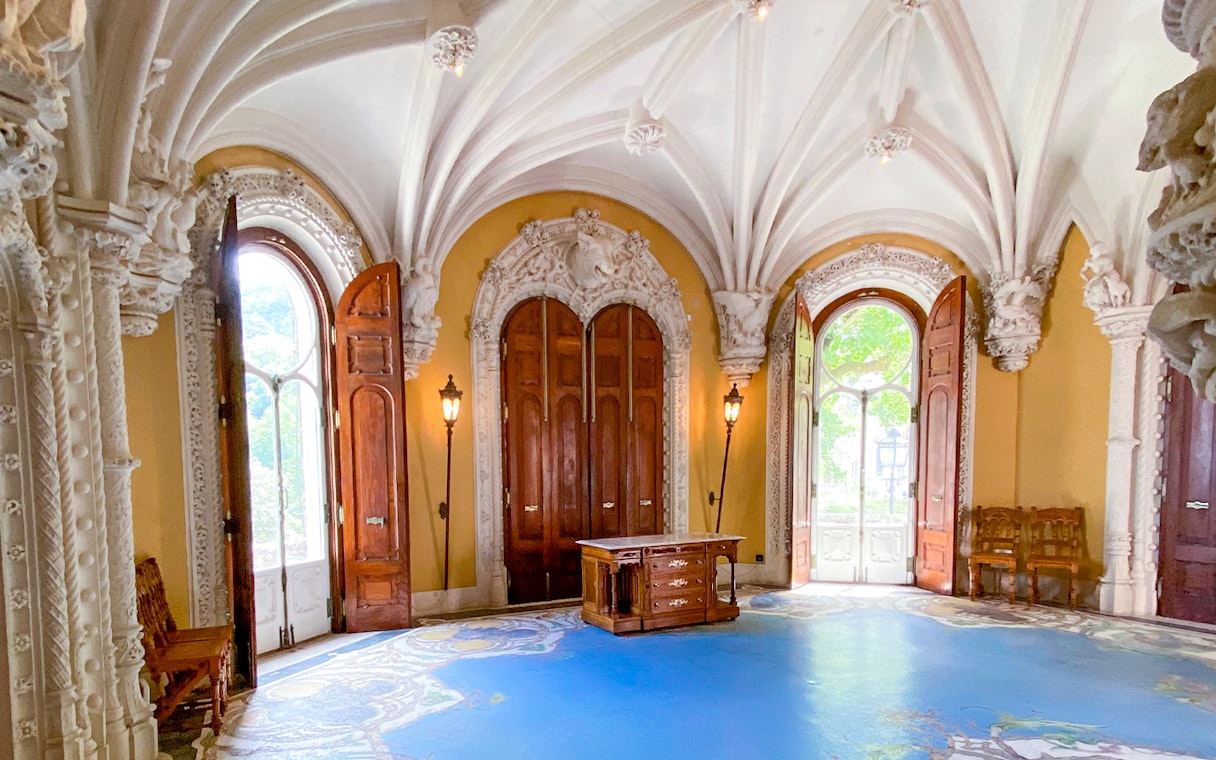 Quinta da Regaleira ornate room with arched ceiling and wooden doors in Sintra, Portugal.