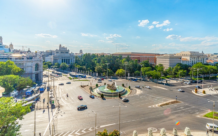 Cibeles fountain and Madrid traffic viewed from City Hall, with Paseo del Prado in the background.