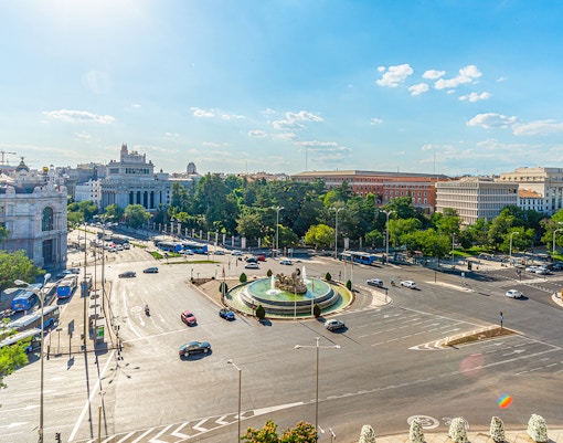 Cibeles fountain and Madrid traffic viewed from City Hall, with Paseo del Prado in the background.