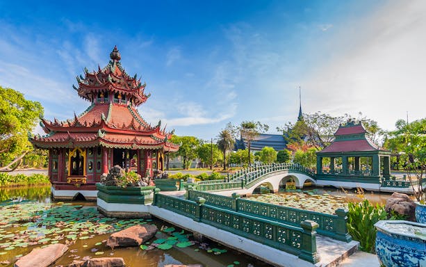 Pagoda and bridge over pond in Ancient City Park, Thailand.
