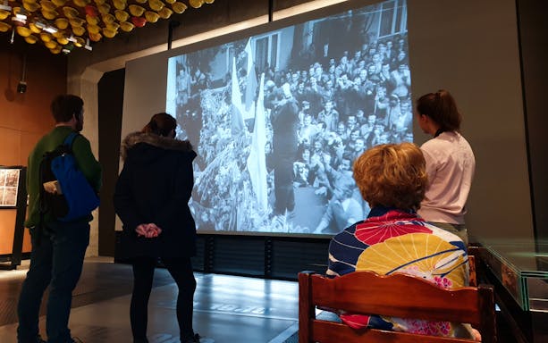 Tourists viewing historical footage at the European Solidarity Center.