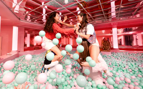 Visitors playing in a colorful ball pit at The Upside Down Berlin.