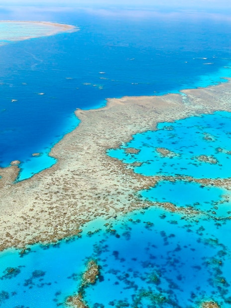 Aerial view of the Great Barrier Reef's vibrant coral formations in the Whitsundays.
