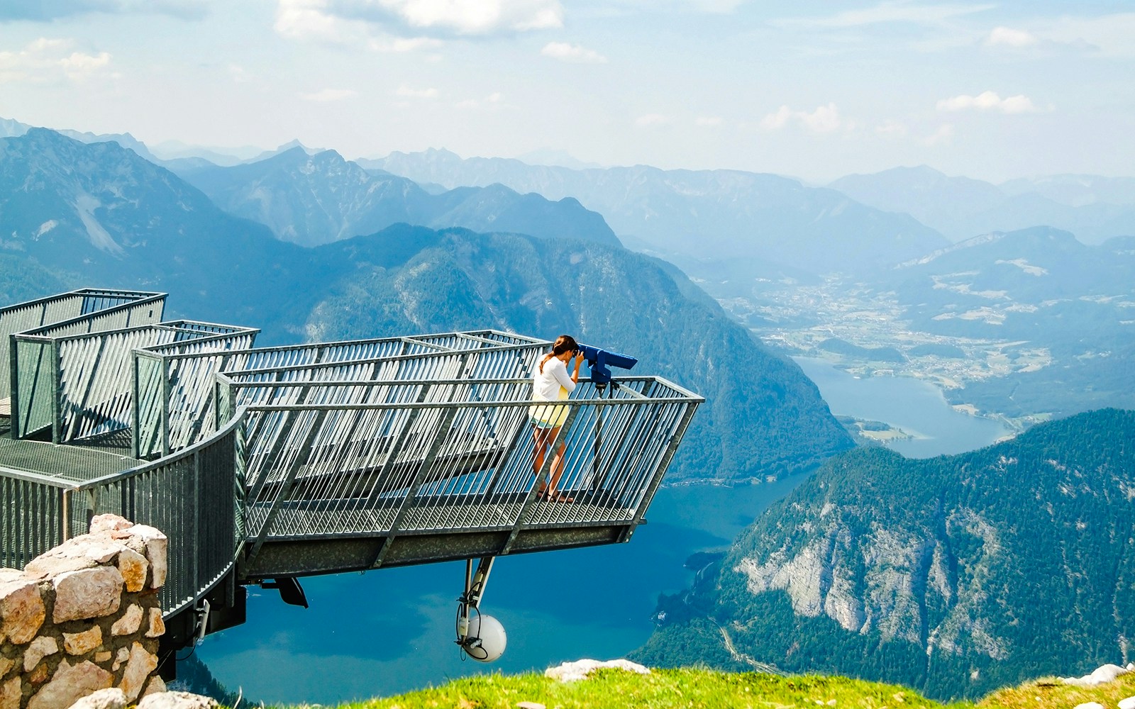 Young girl using binoculars on Five Fingers viewing platform, Alps.