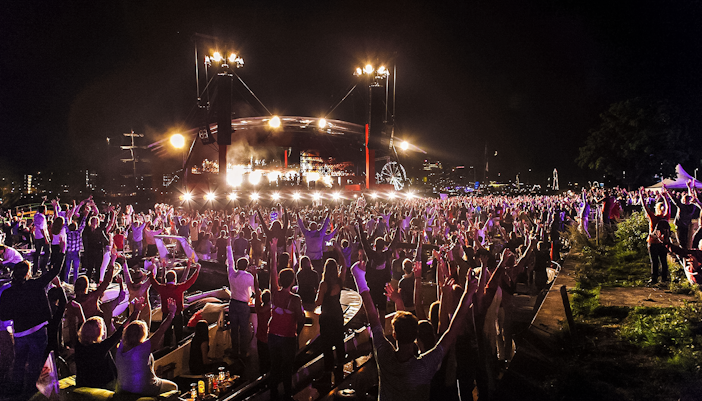 Crowd enjoying a night event with live music during Sail Amsterdam.