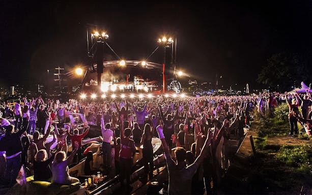 Crowd enjoying a night event with live music during Sail Amsterdam.