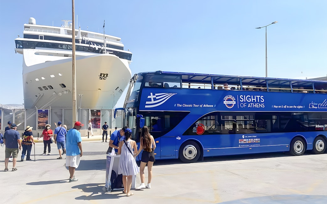 Athens hop-on hop-off bus near cruise ship with tourists boarding.