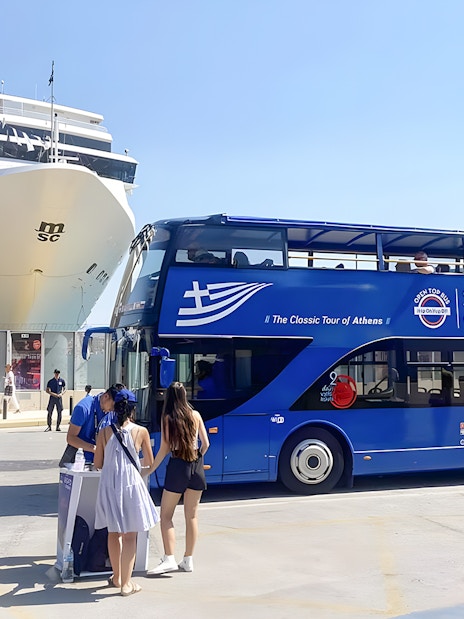 Athens hop-on hop-off bus near cruise ship with tourists boarding.