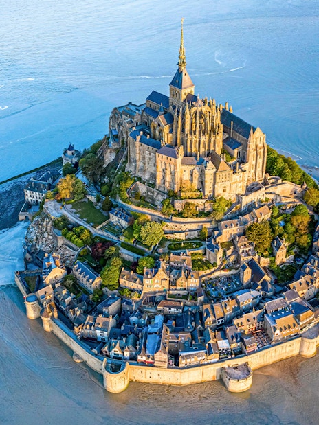 Mont Saint-Michel aerial view with abbey and surrounding bay in Normandy, France.