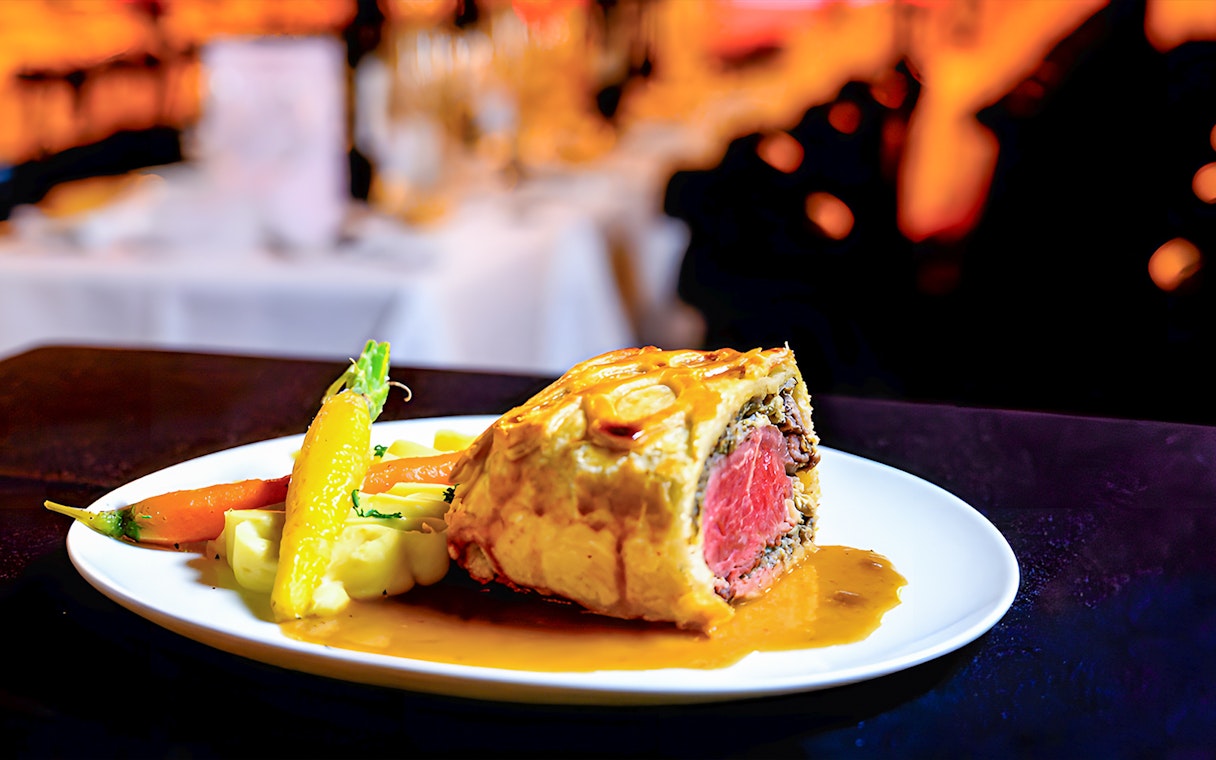 Beef Wellington served with vegetables at Paradis Latin.