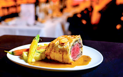 Beef Wellington served with vegetables at Paradis Latin.